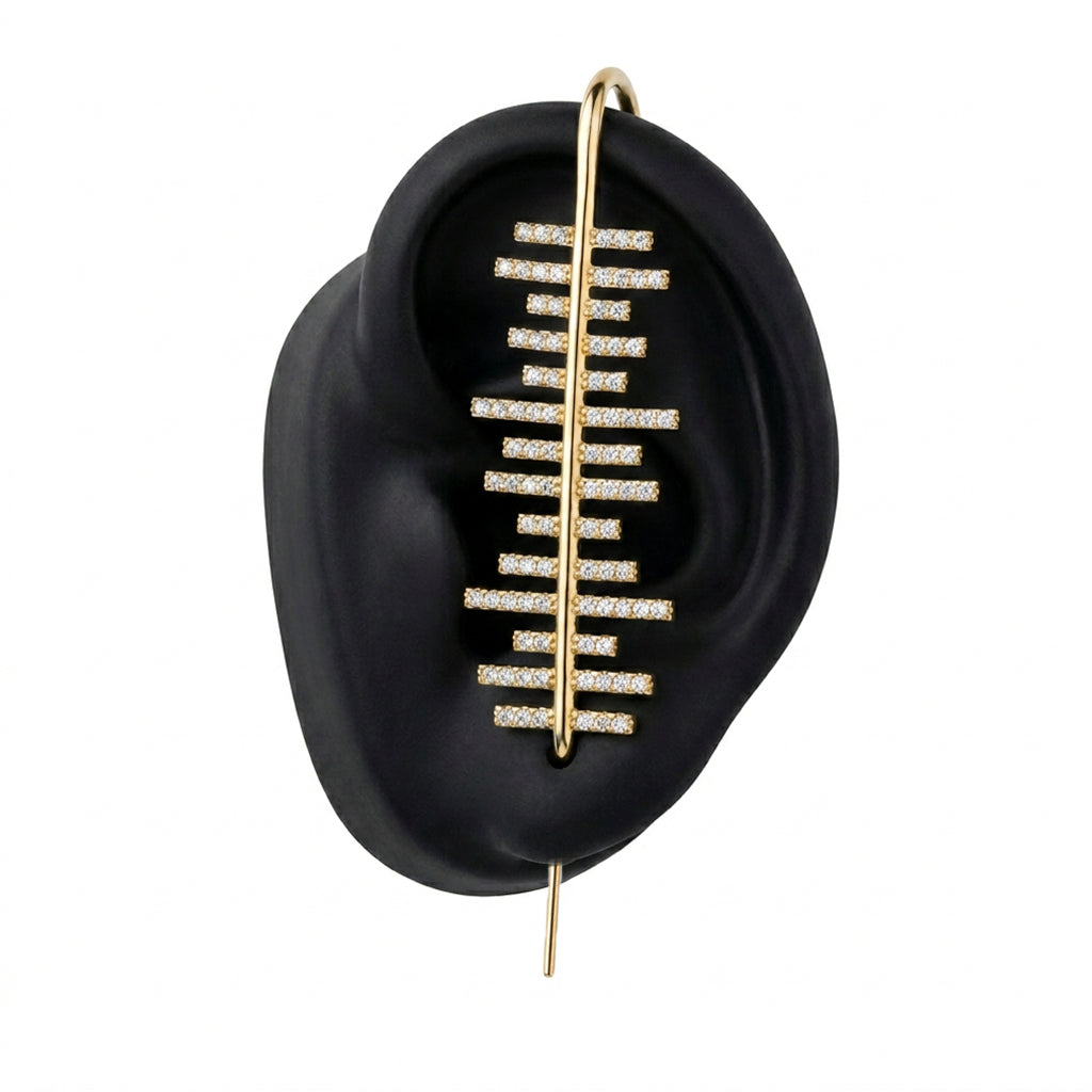 Balance ear cuff in gold on a black ear form