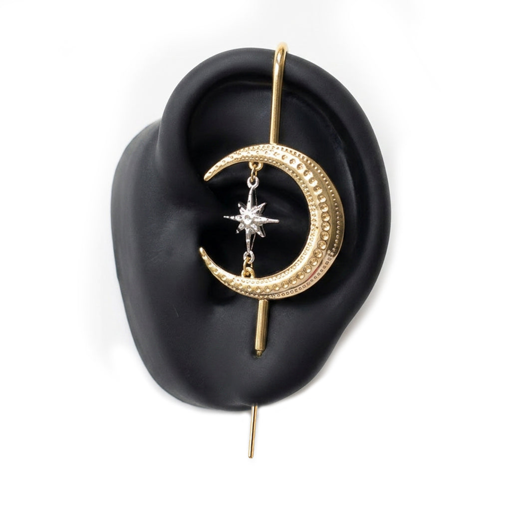 Cosmic Connection ear cuff in gold on a black ear form