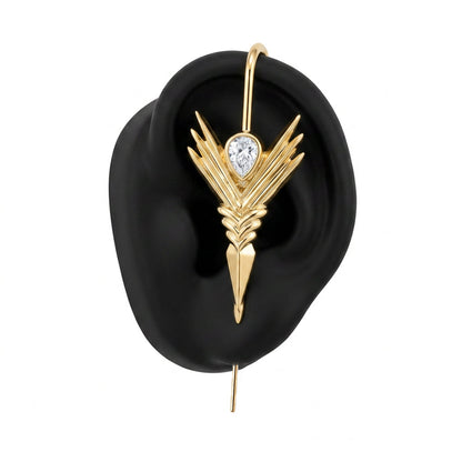 Cosmic Wand ear cuff in gold on a black ear form