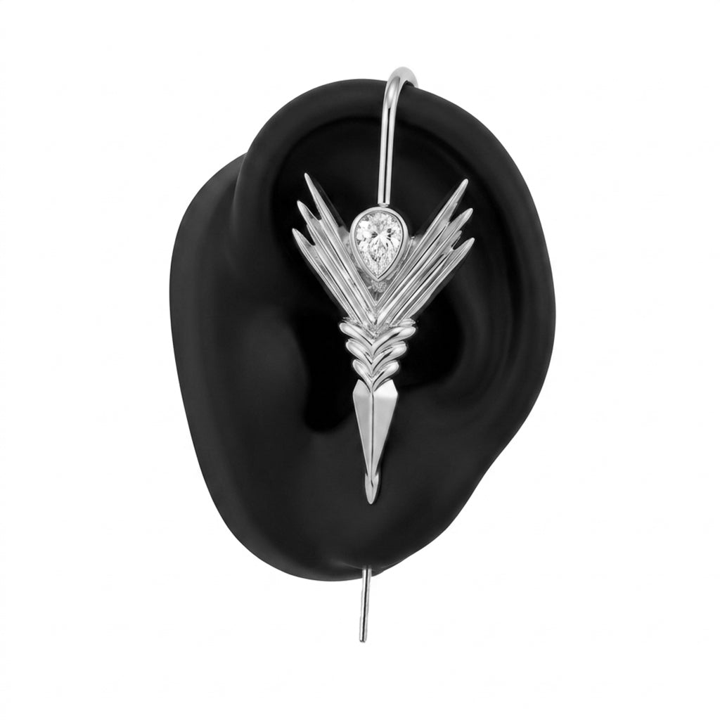 Cosmic Wand ear cuff in silver on a black ear form