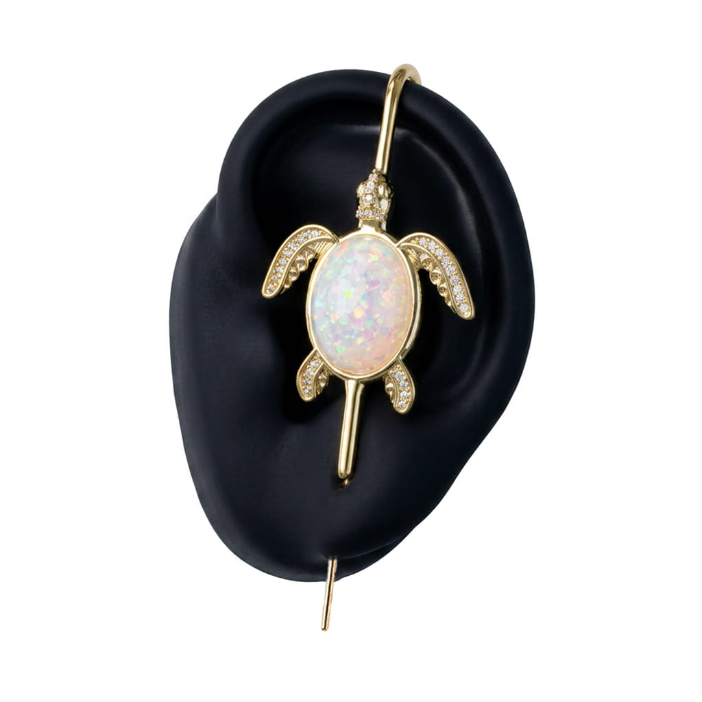 Ocean Guardian ear cuff in gold on a black ear form