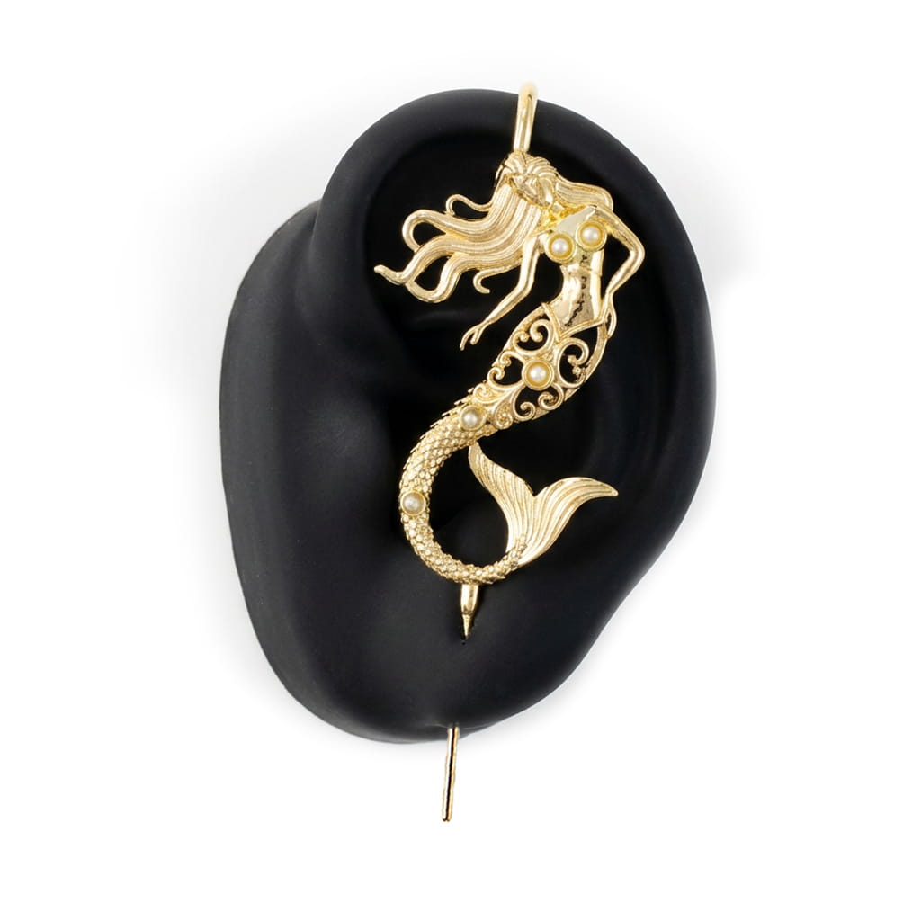 Ocean Siren ear cuff in gold on a black ear form