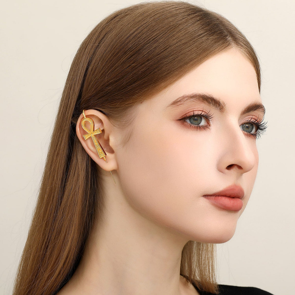 Ankh ear cuff worn on the ear, profile view