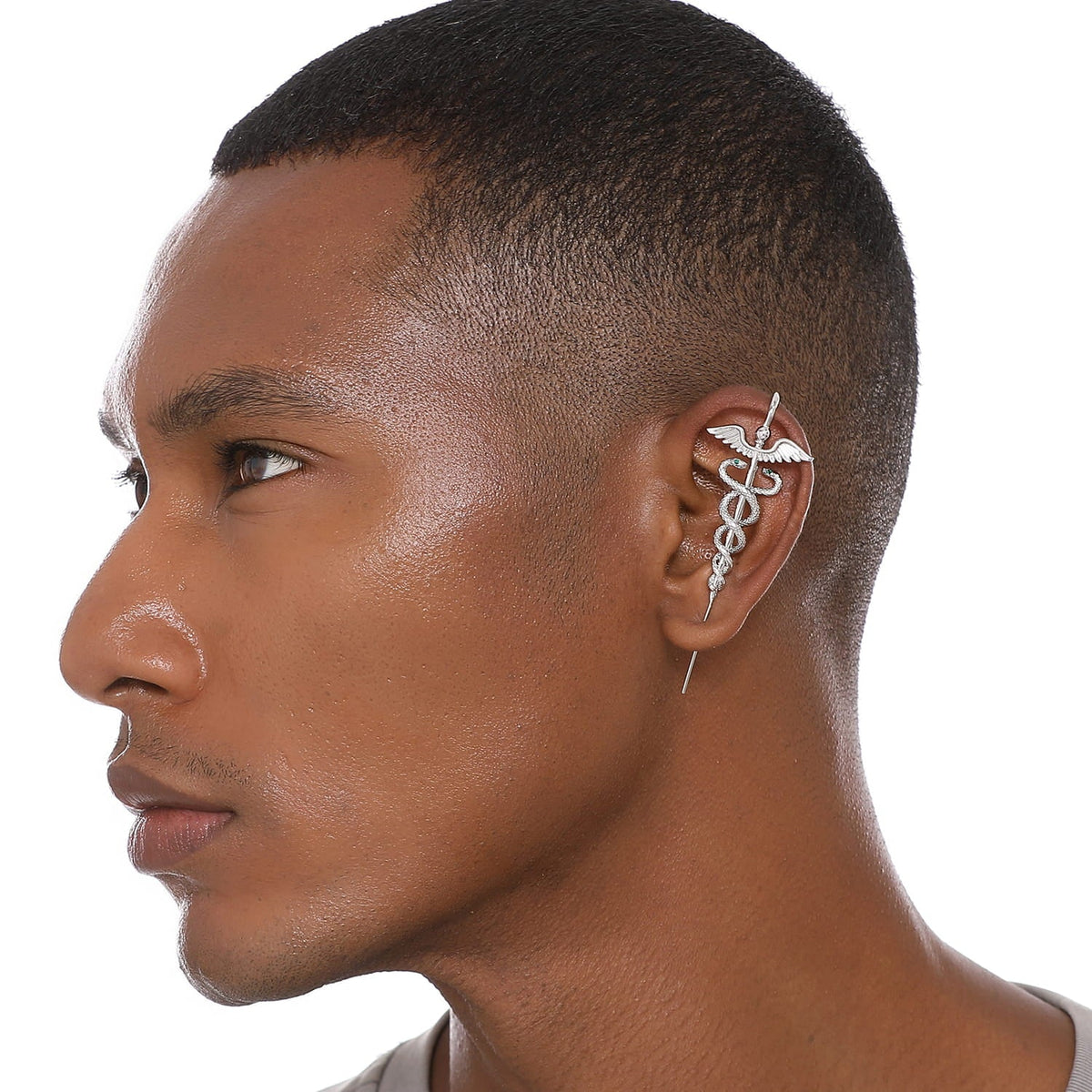 Caduceus ear cuff worn on the ear, profile view
