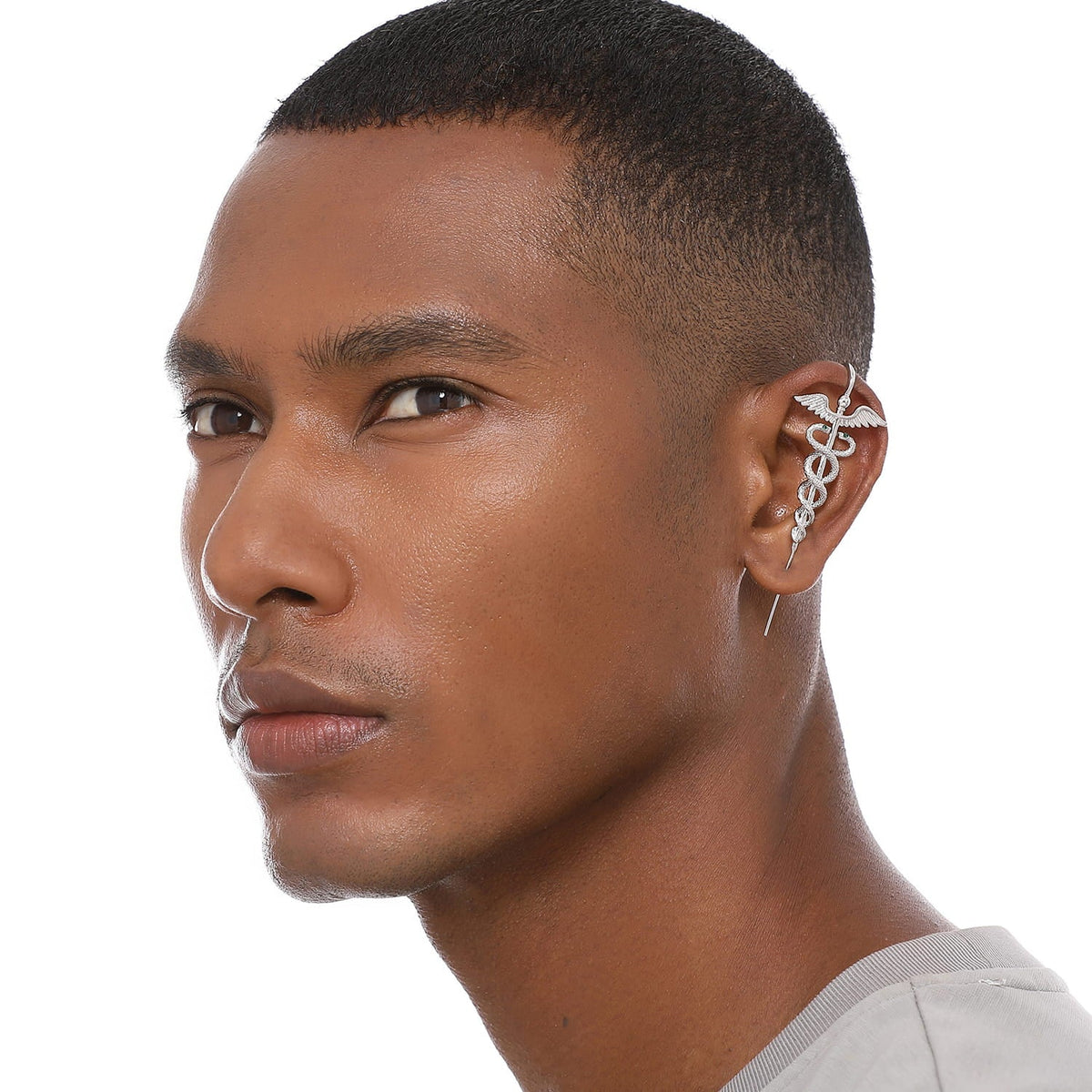 Caduceus ear cuff worn on the ear, profile view