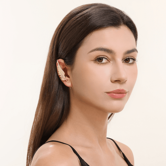 Celestial Wing ear cuff in gold worn on the ear, profile view