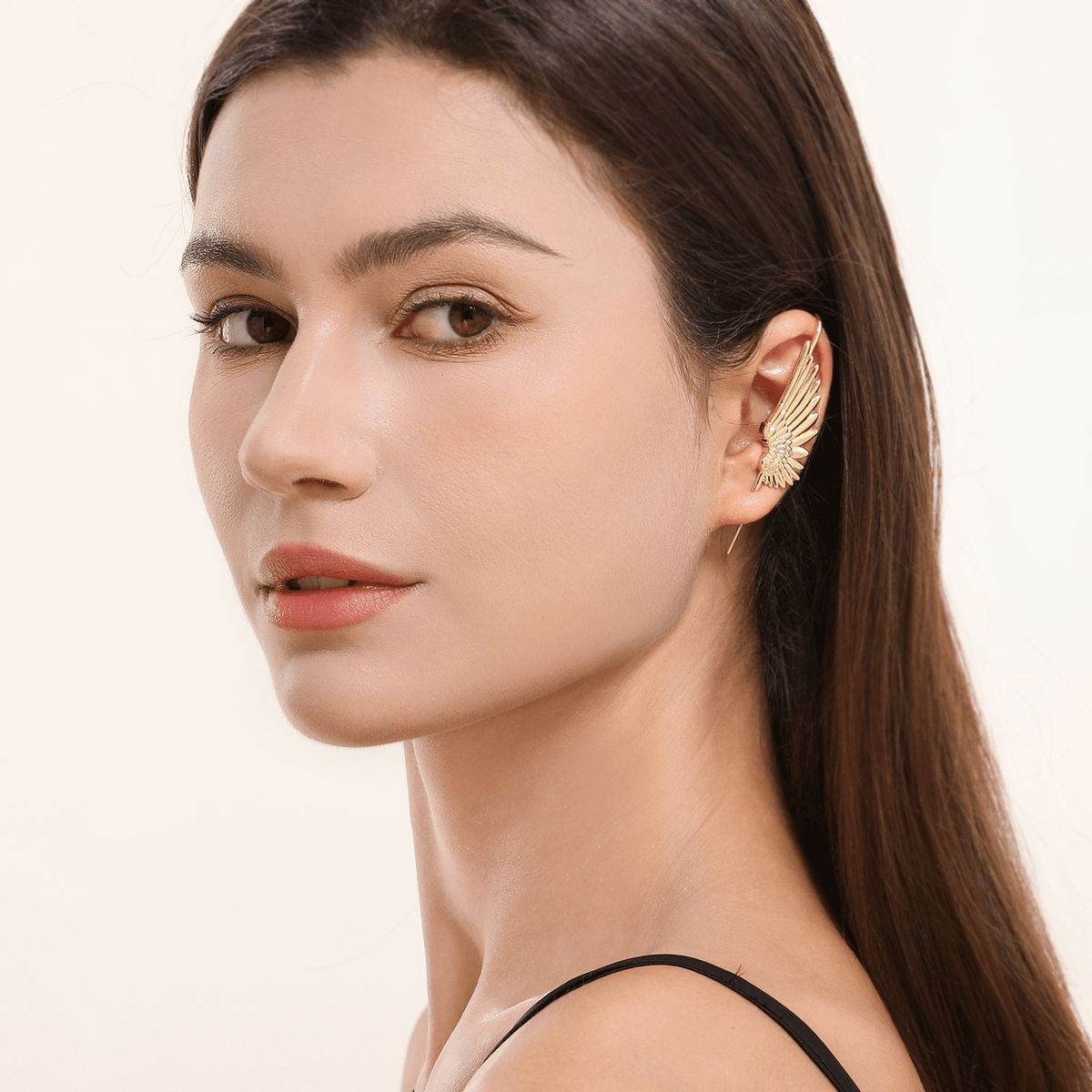 Celestial Wing ear cuff in gold worn on the ear, profile view
