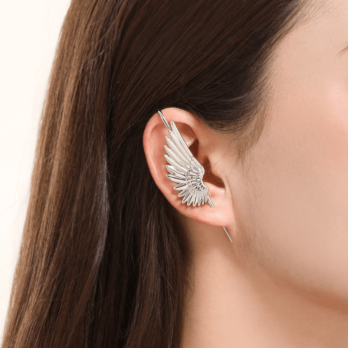 Celestial Wing ear cuff in silver worn on the ear, profile view