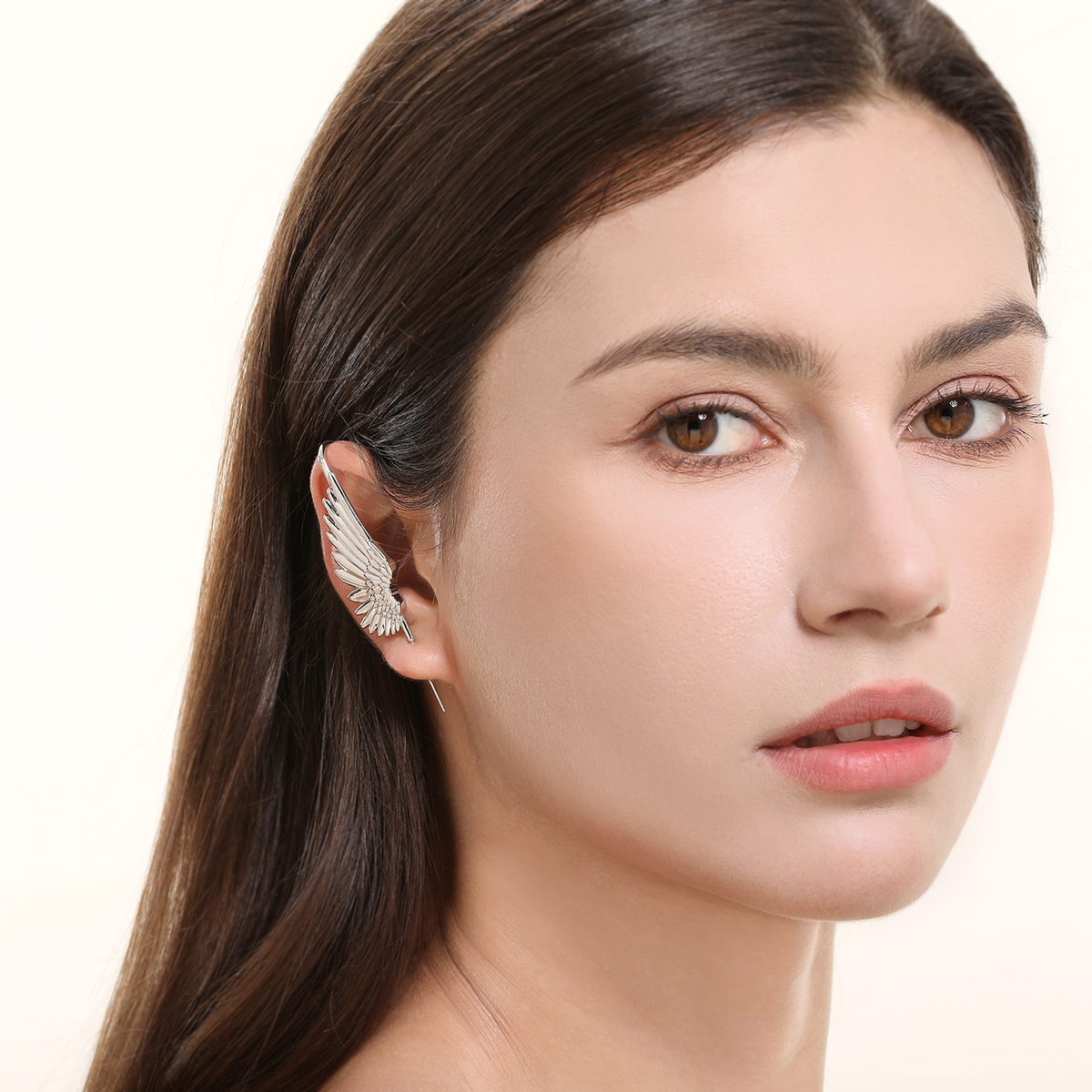 Celestial Wing ear cuff in silver worn on the ear, profile view