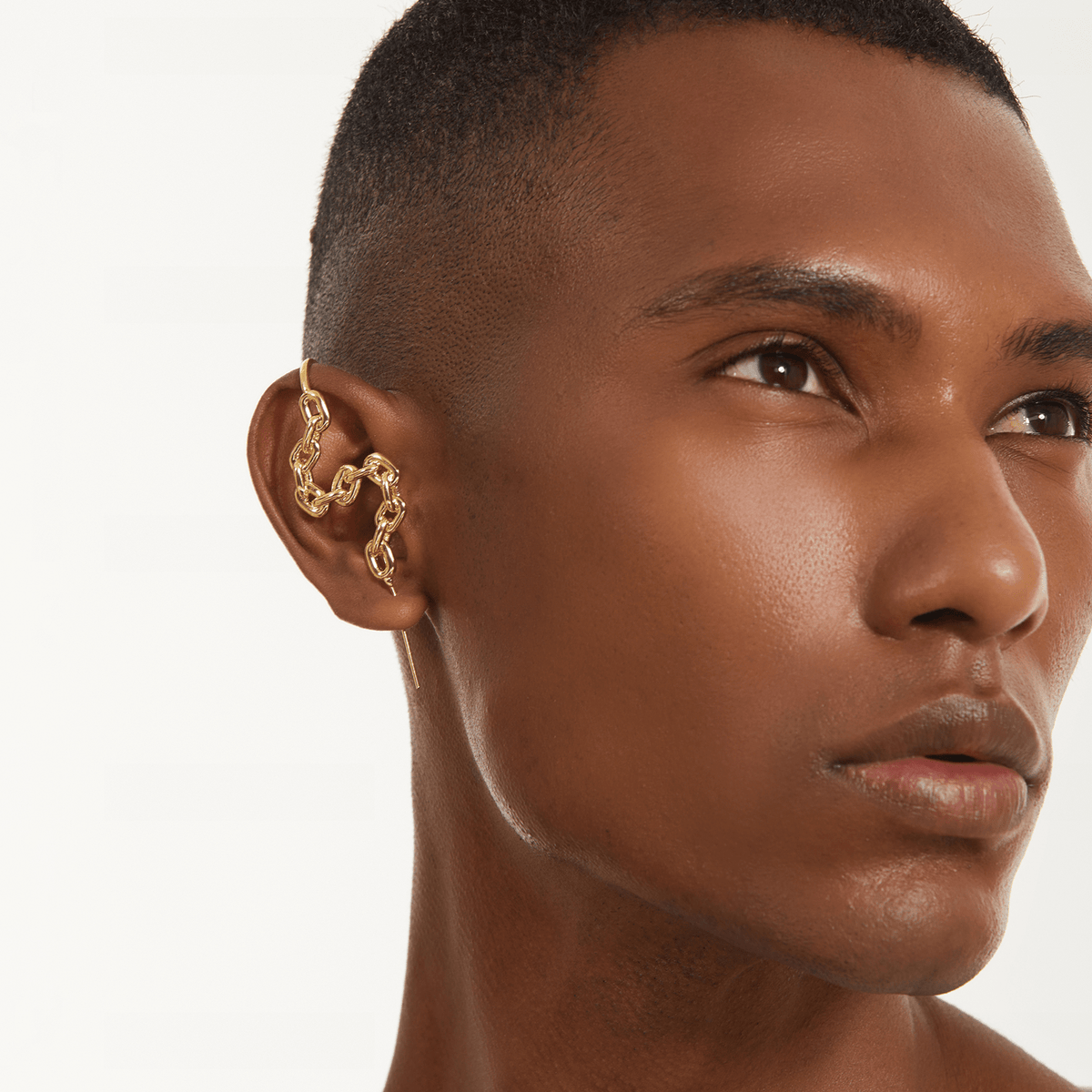 Chain-Link ear cuff in gold worn on the ear, profile view