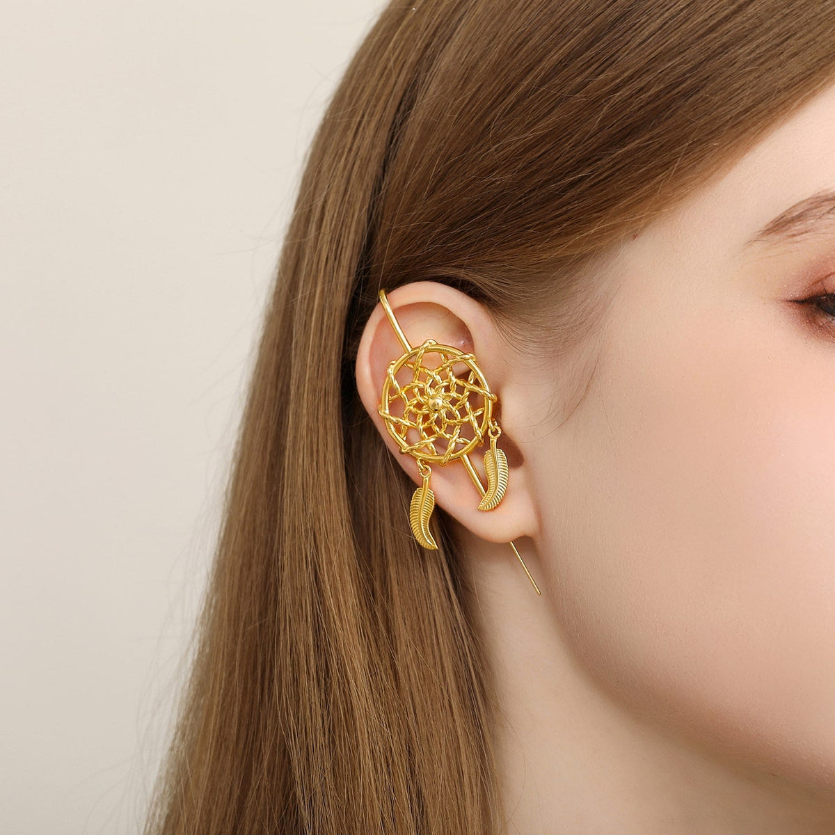 Dreamcatcher ear cuff worn on the ear, profile view