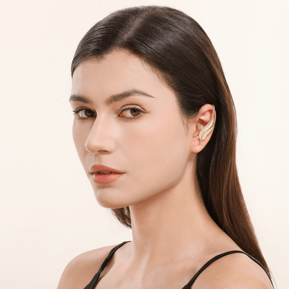 Feathered Grace ear cuff in gold worn on the ear, profile view