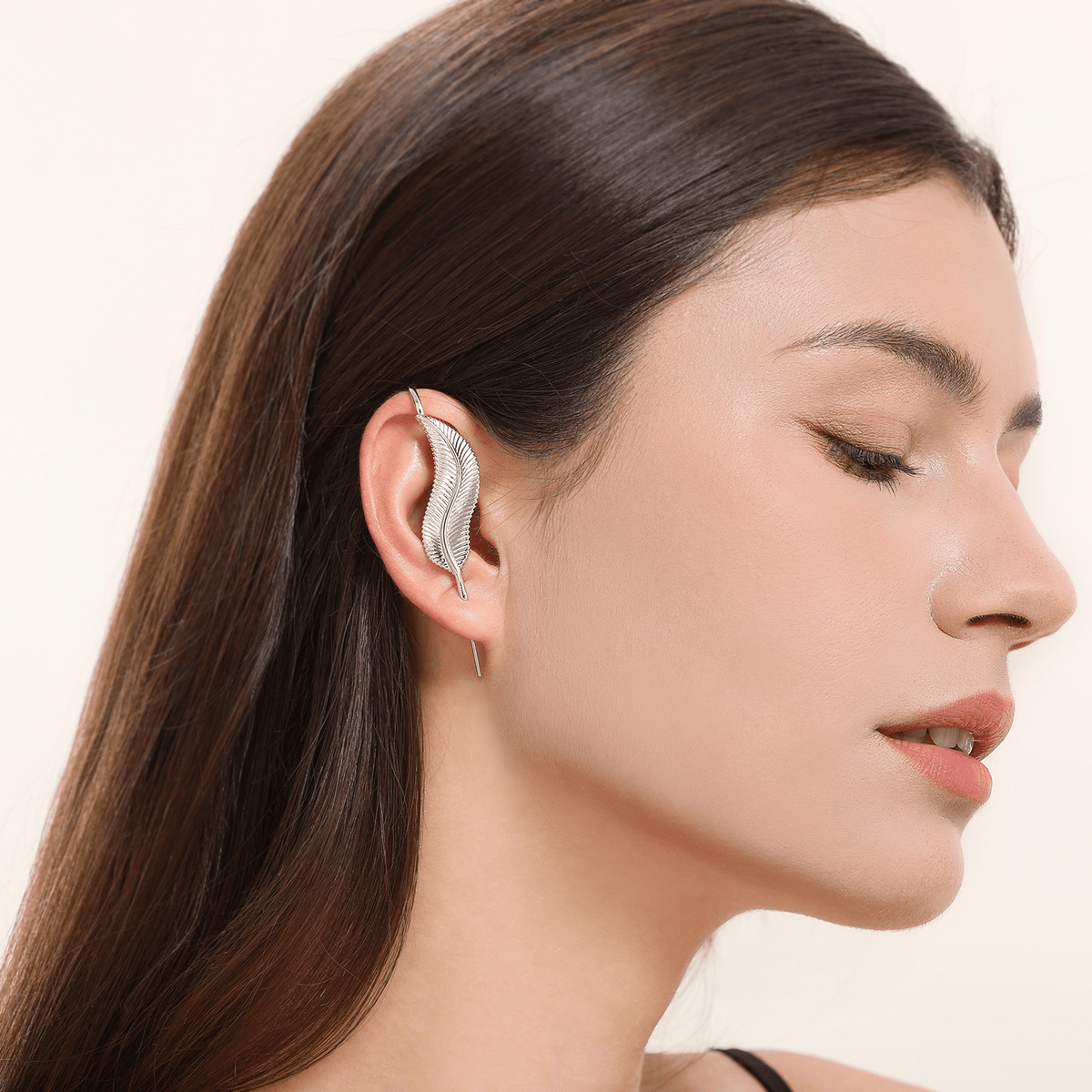 Feathered Grace ear cuff in silver worn on the ear, profile view