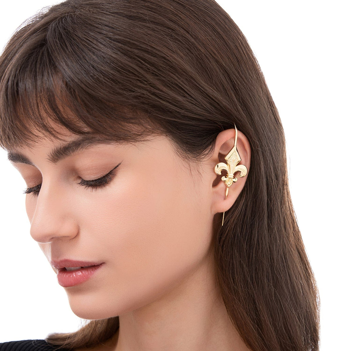 Fleur De Lys ear cuff worn on the ear, profile view