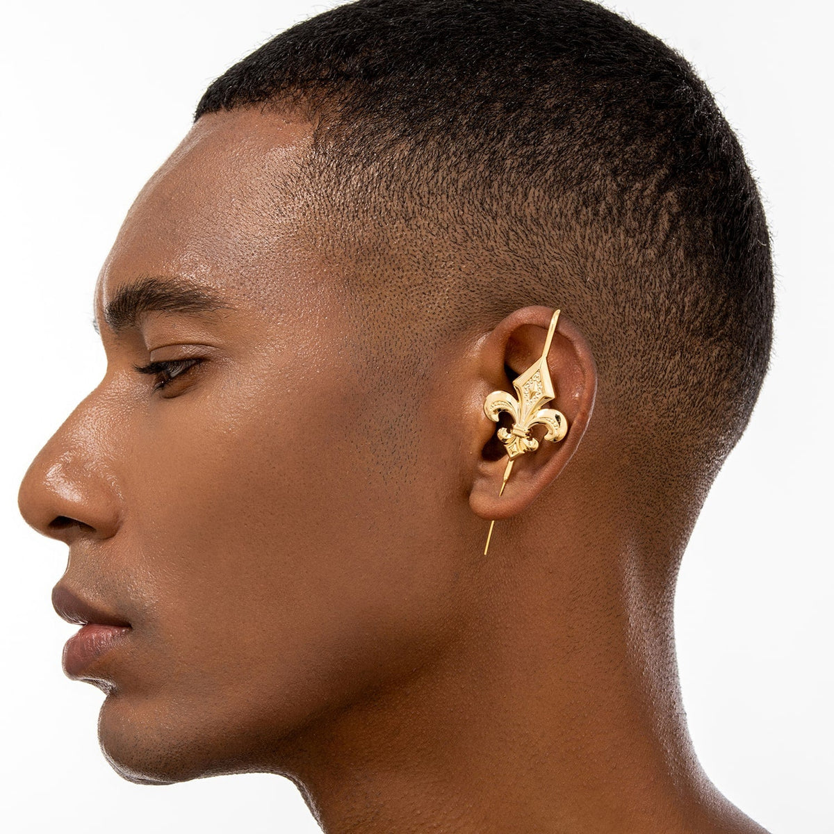 Fleur De Lys ear cuff worn on the ear, profile view