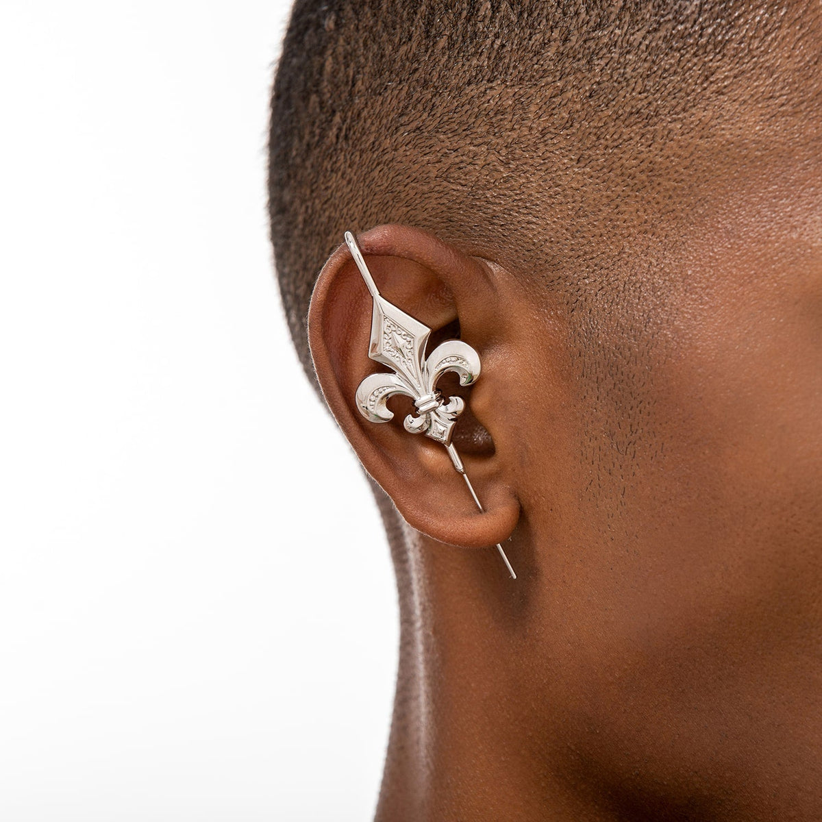 Fleur De Lys ear cuff worn on the ear, profile view