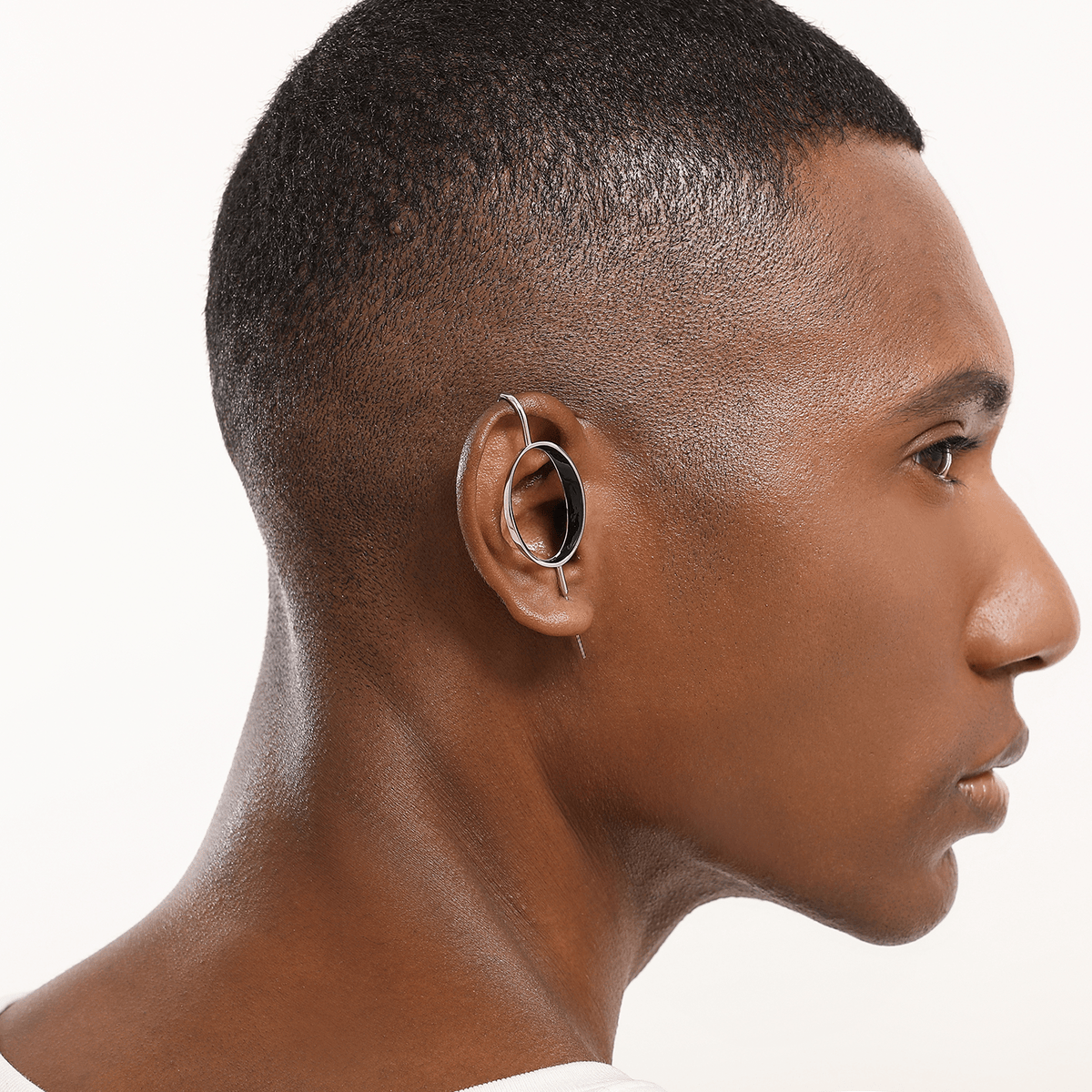 Halo ear cuff in silver worn on the ear, profile view
