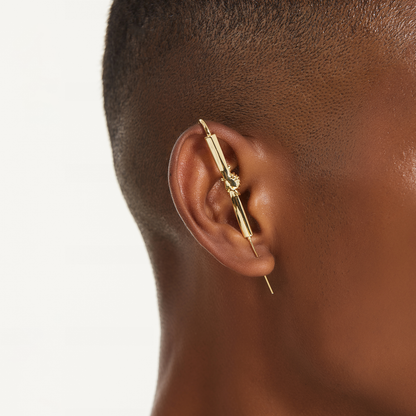Helping Hand ear cuff in gold worn on the ear, profile view