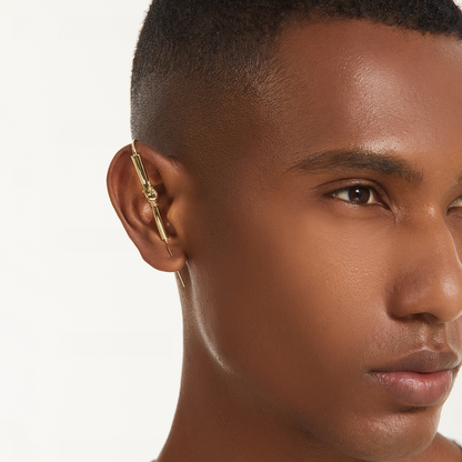 Helping Hand ear cuff in gold worn on the ear, profile view