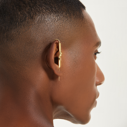 Helping Hand ear cuff in gold worn on the ear, profile view