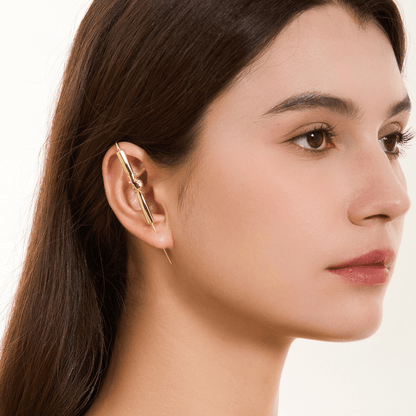 Helping Hand ear cuff in gold worn on the ear, profile view
