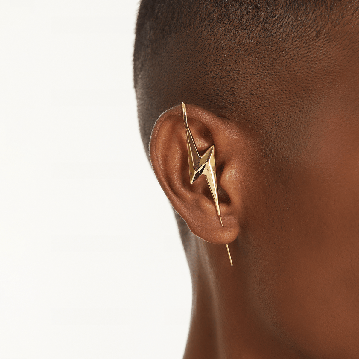Lightning Bolt ear cuff in gold worn on the ear, profile view