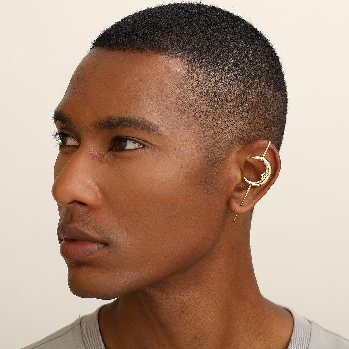 Sun & Moon ear cuff in gold worn on the ear, profile view