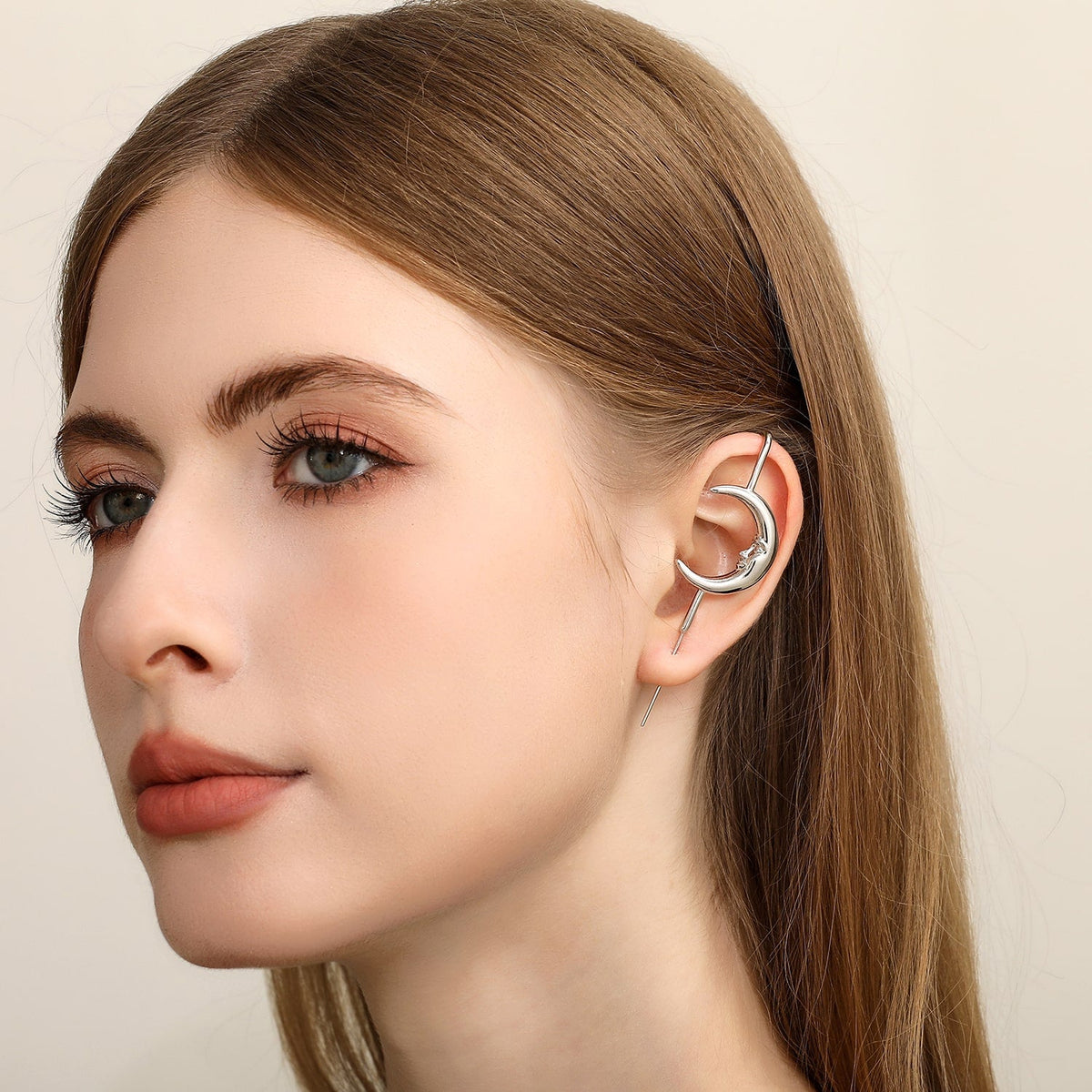 Sun & Moon ear cuff in silver worn on the ear, profile view