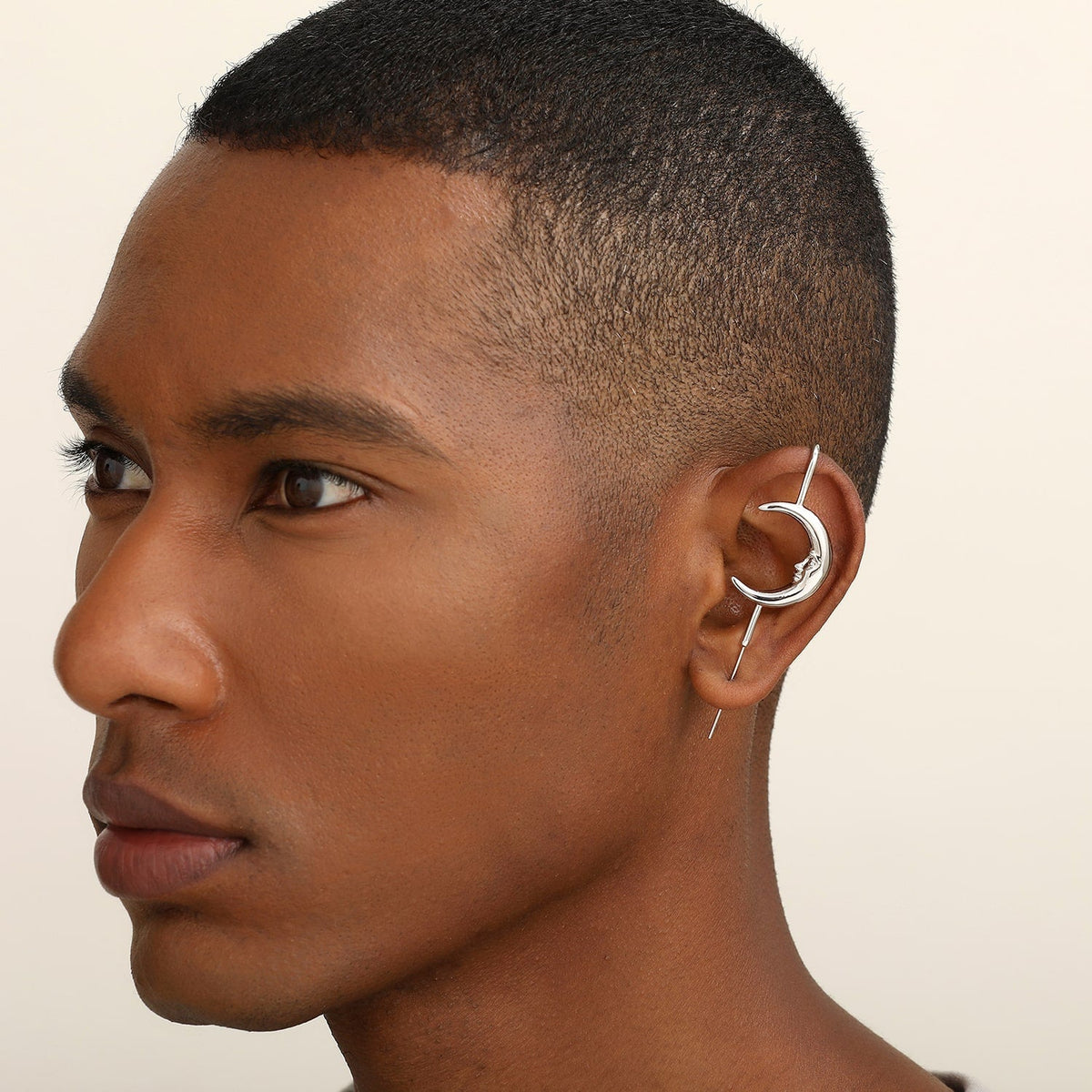 Sun & Moon ear cuff in silver worn on the ear, profile view
