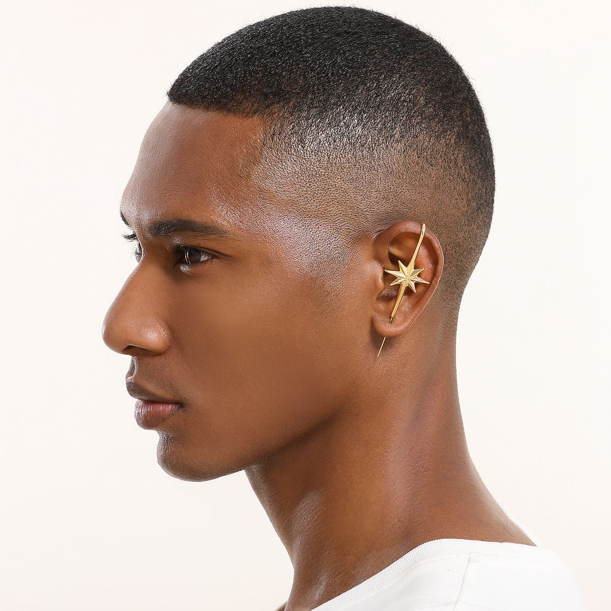 North Star ear cuff in gold worn on the ear, profile view