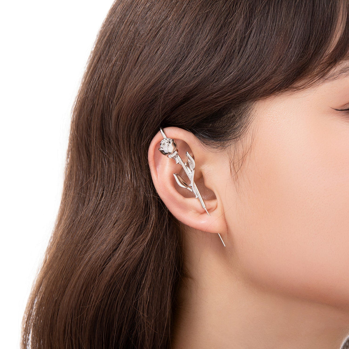 Radiant Rose ear cuff worn on the ear, profile view