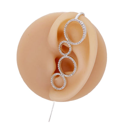 Linked Circles ear cuff in silver on a black ear form