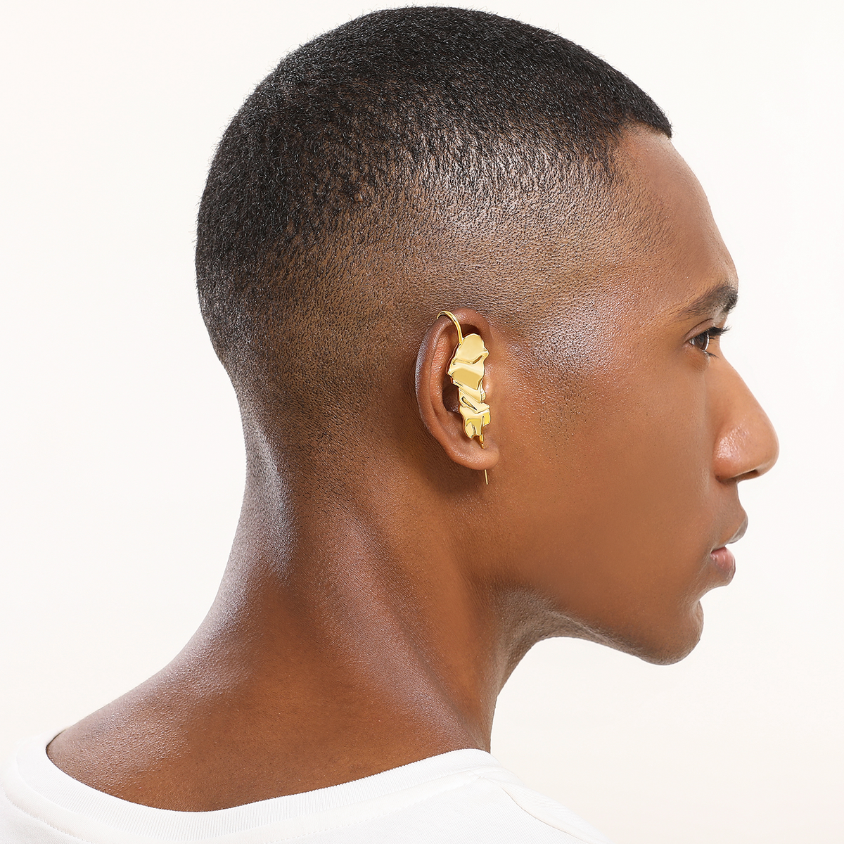 Sculpted Cascade ear cuff in gold worn on the ear, profile view
