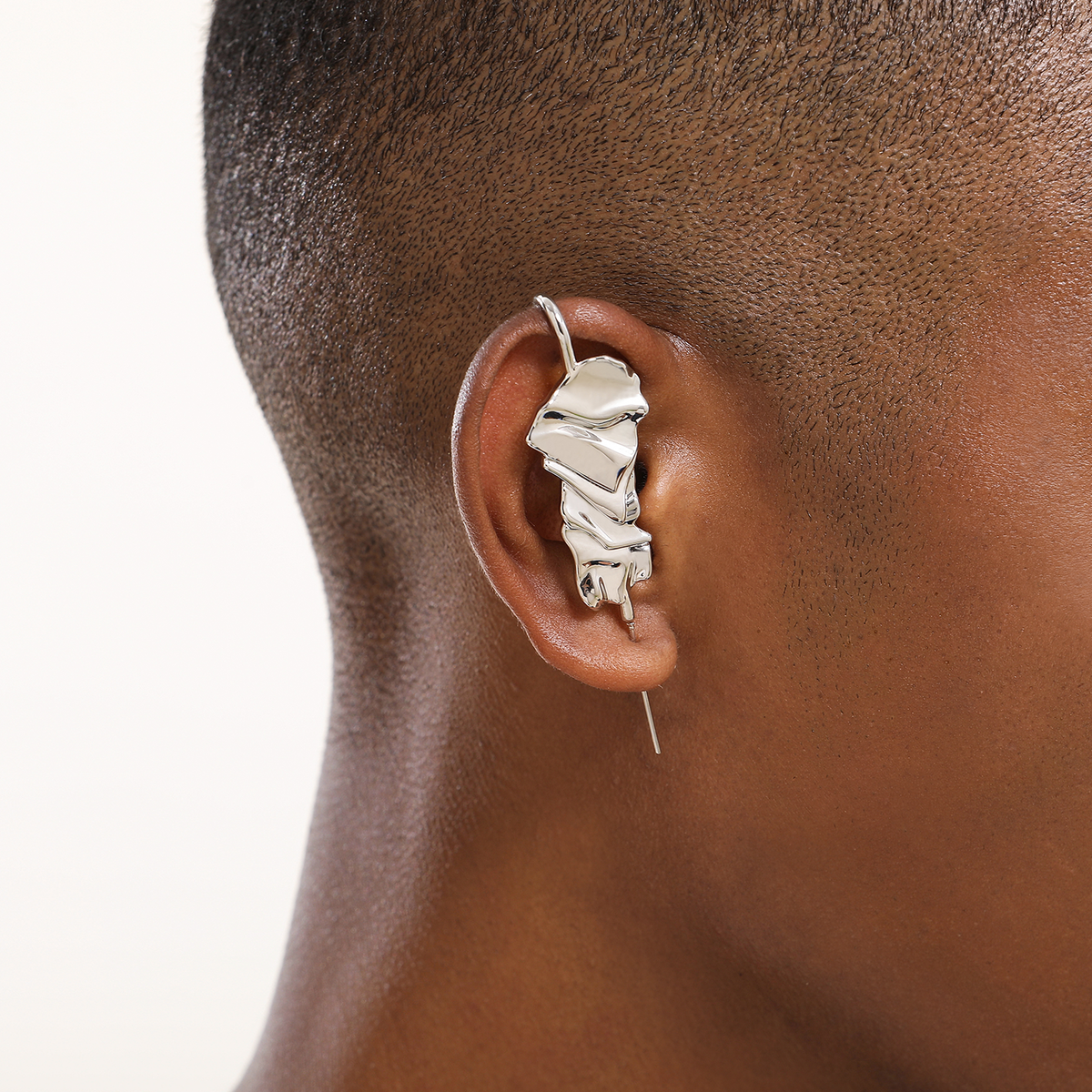 Sculpted Cascade ear cuff in silver worn on the ear, profile view