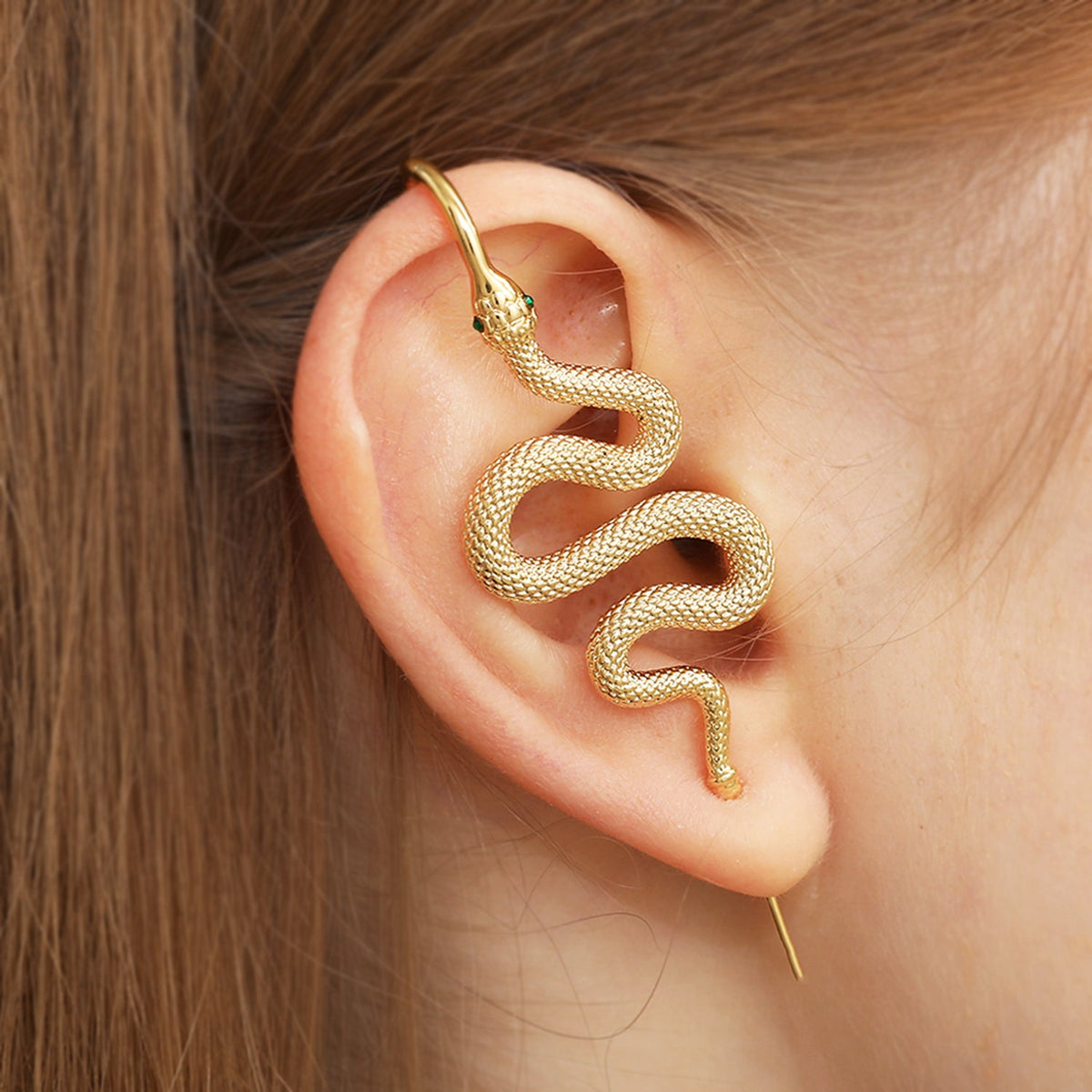 Serpent ear cuff worn on the ear, profile view