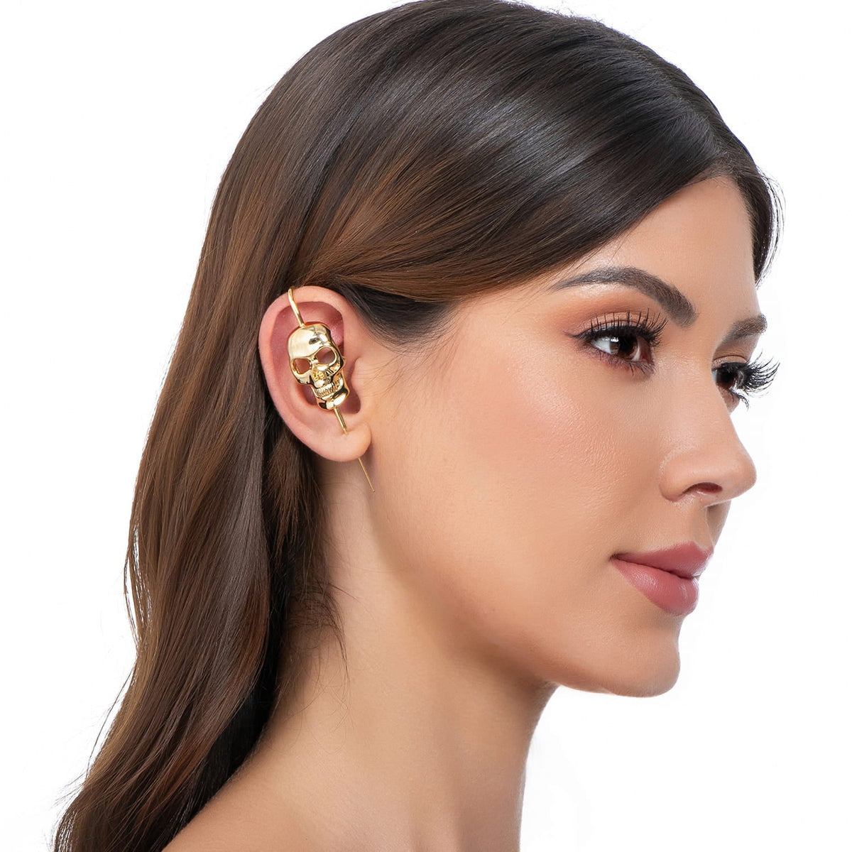 Memento Mori ear cuff in gold on a black ear form