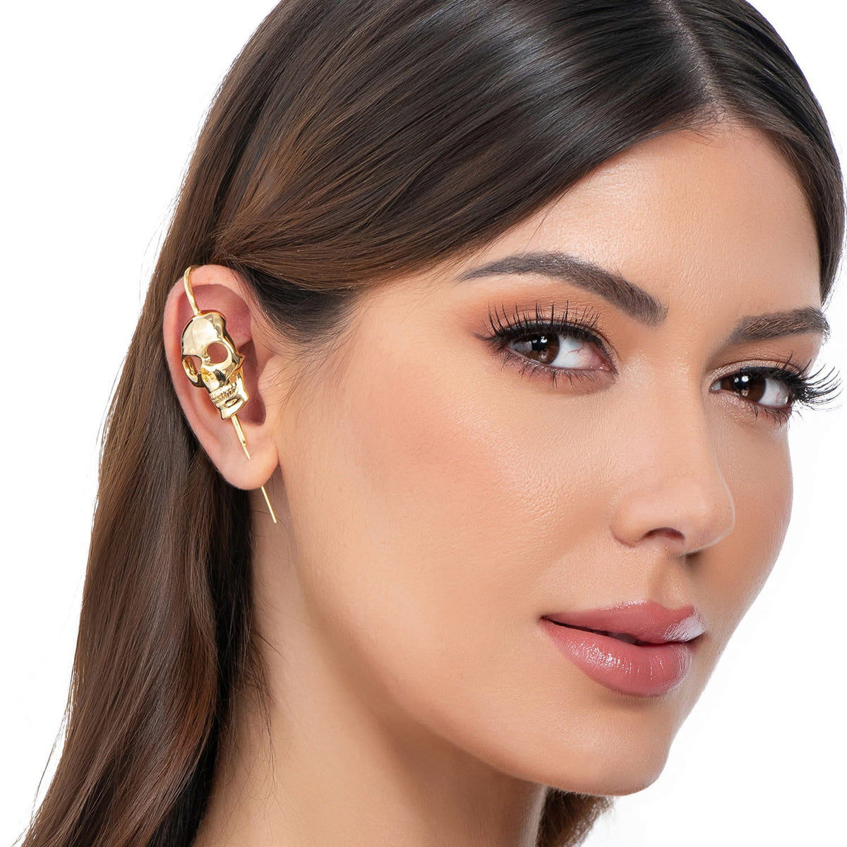 Memento Mori ear cuff in gold on a black ear form