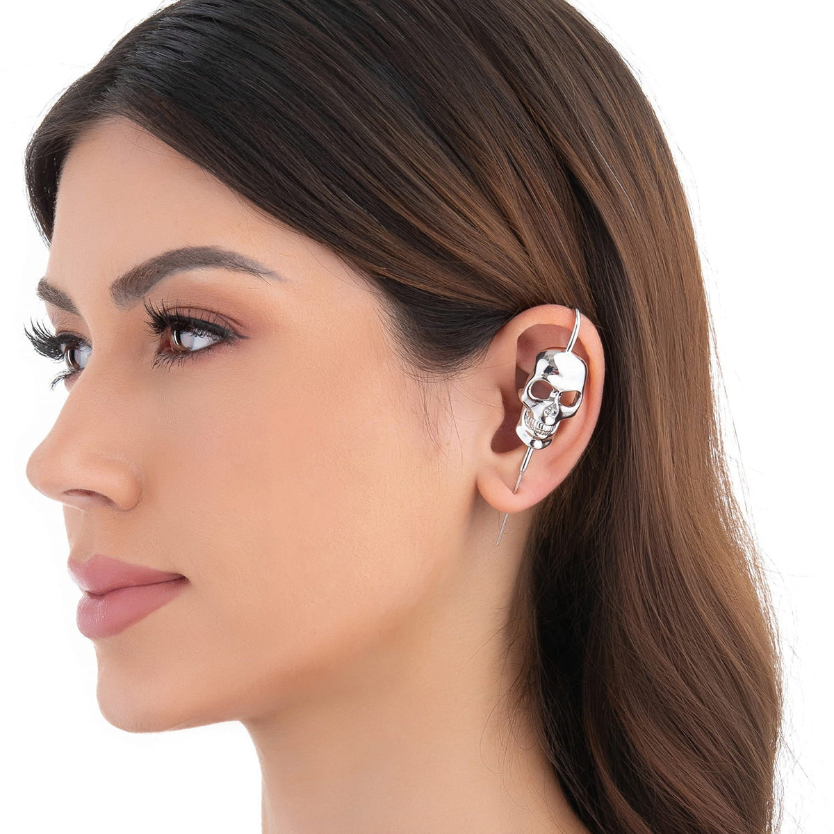 Memento Mori ear cuff in silver on a black ear form