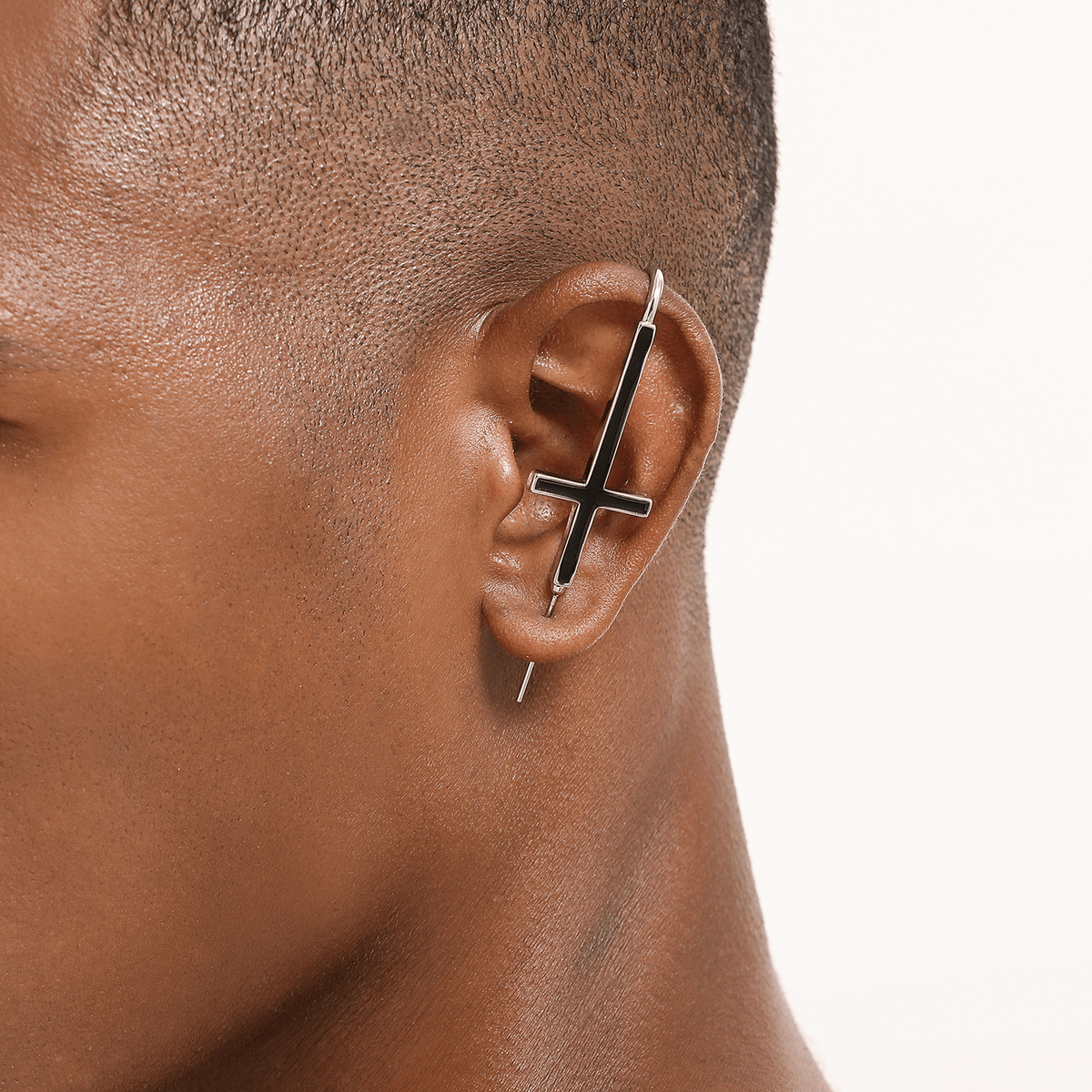 St. Peter Cross ear cuff in silver worn on the ear, profile view