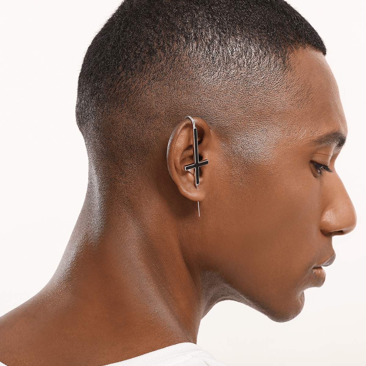 St. Peter Cross ear cuff in silver worn on the ear, profile view
