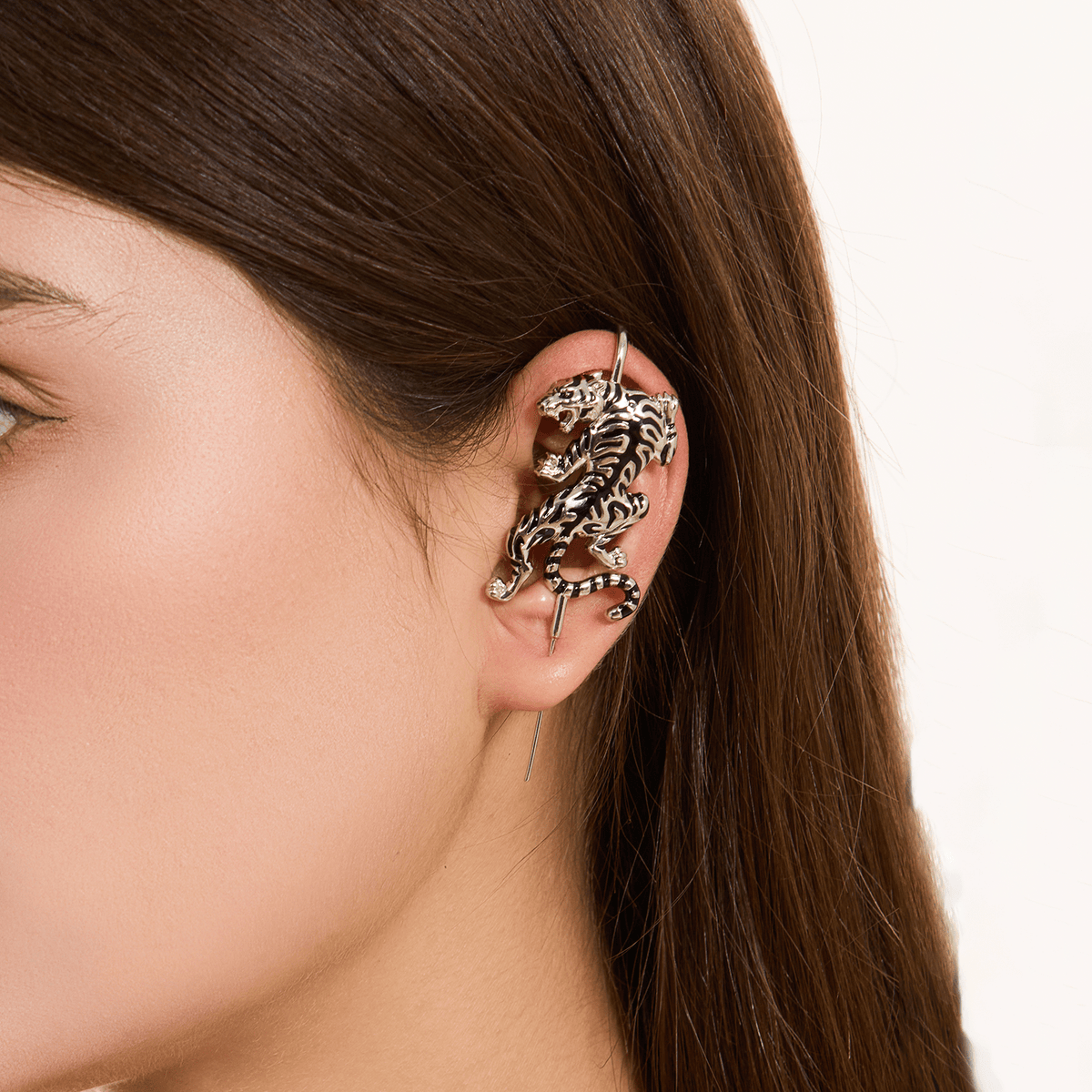 Prowling Tiger ear cuff in silver worn on the ear, profile view
