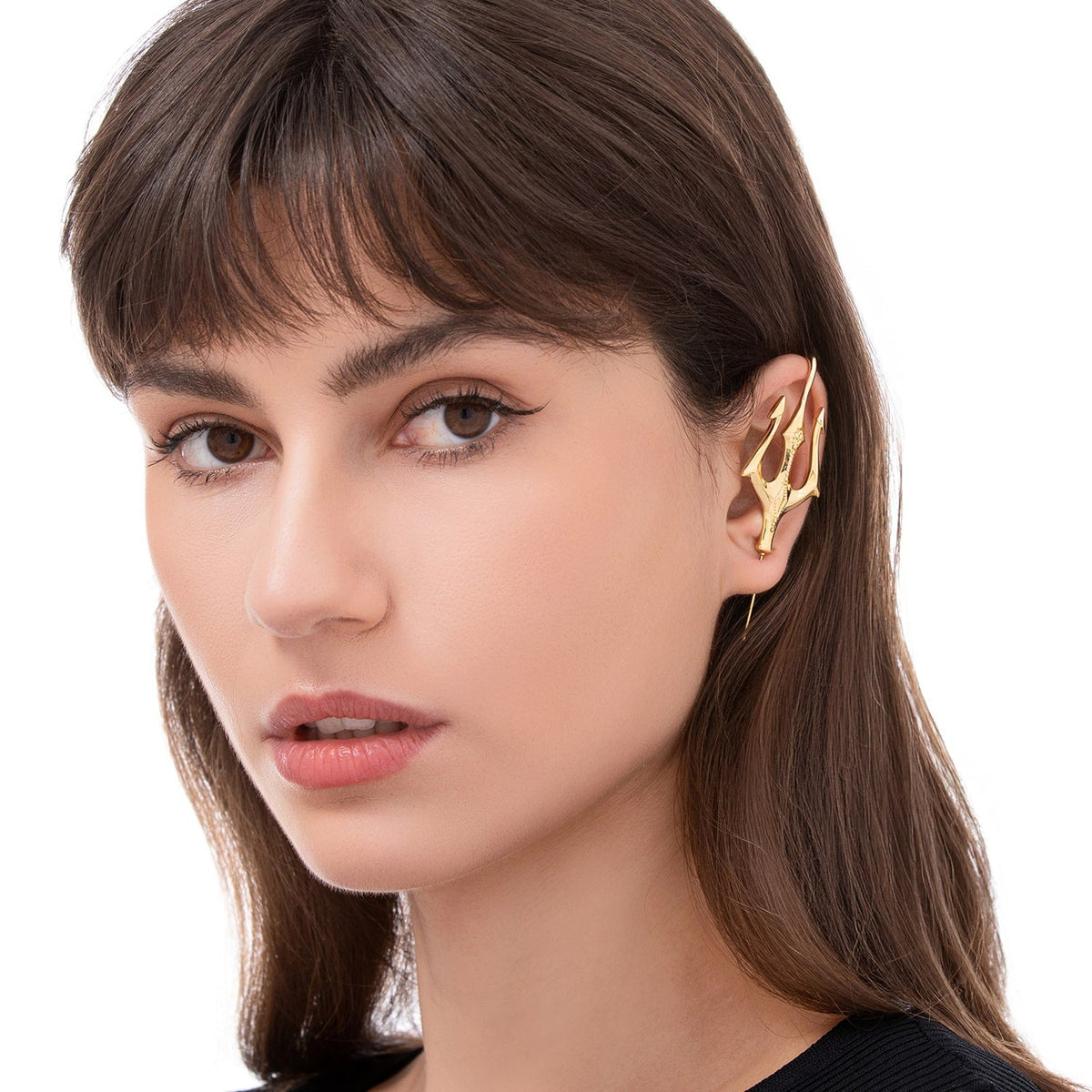Poseidon's Trident ear cuff worn on the ear, profile view