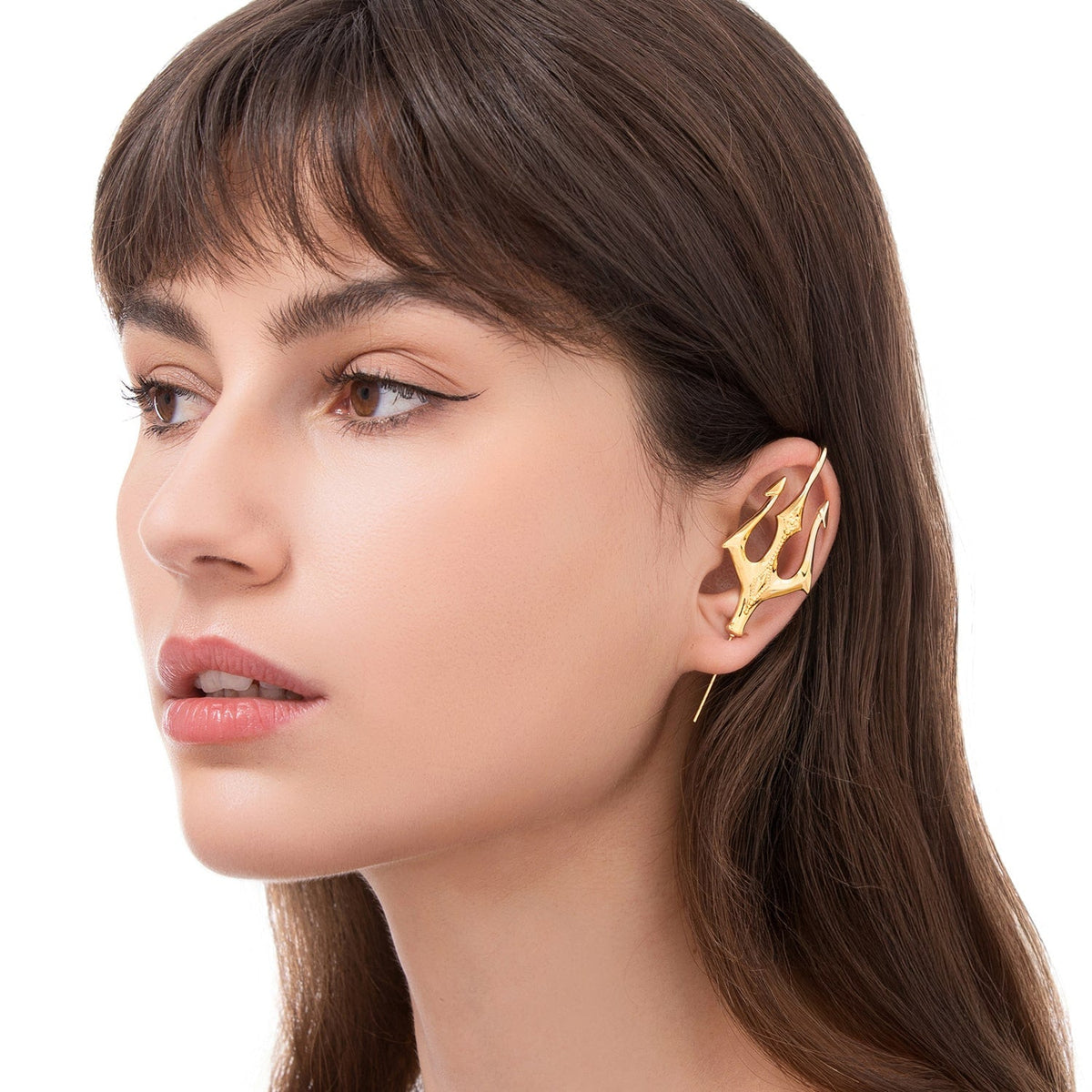Poseidon's Trident ear cuff worn on the ear, profile view