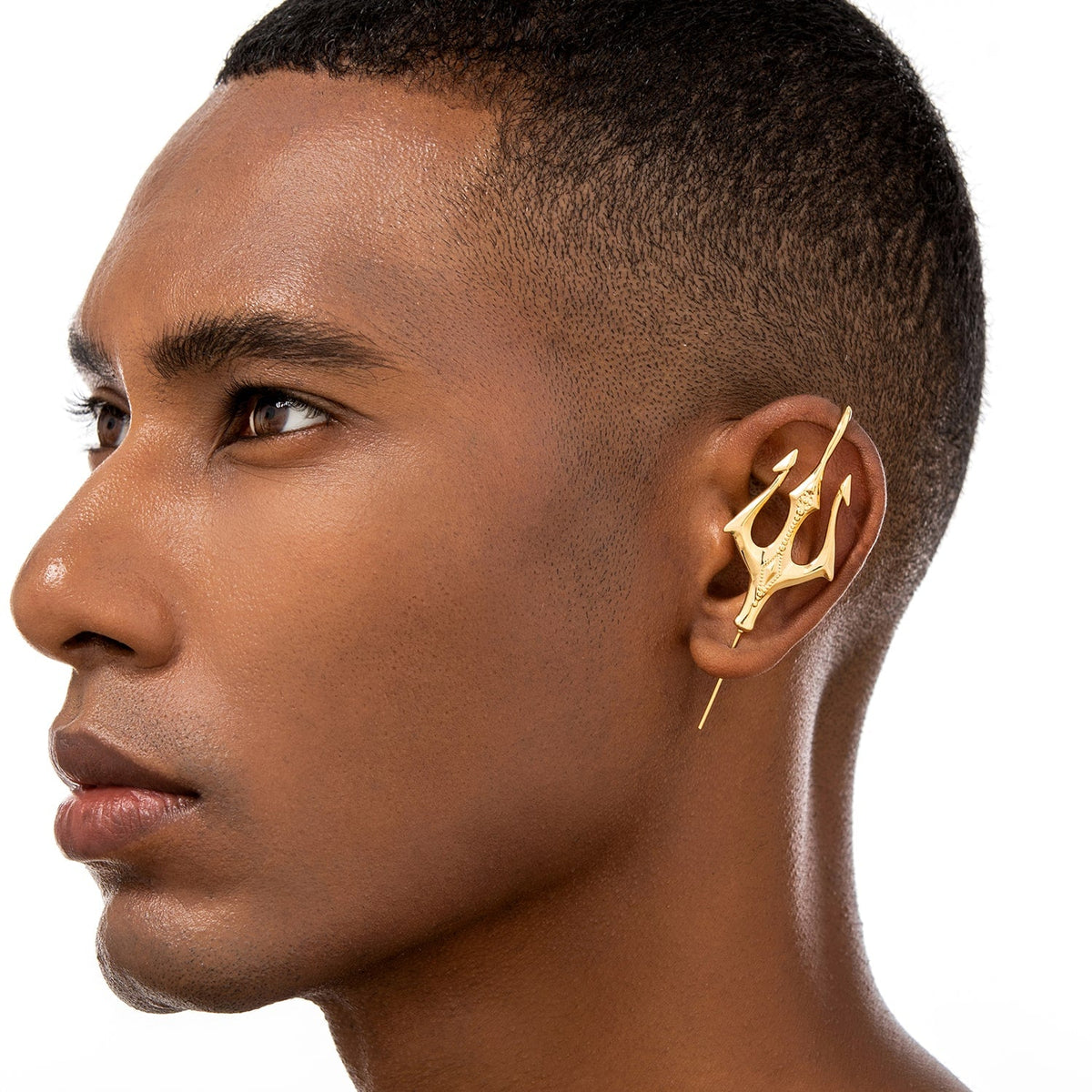 Poseidon's Trident ear cuff worn on the ear, profile view