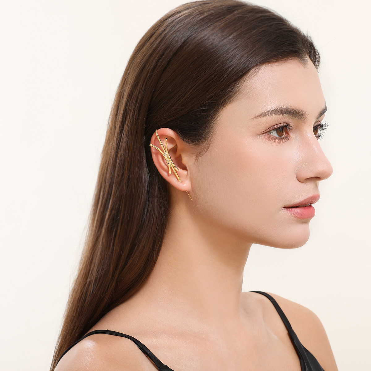 Ward of Protection ear cuff in gold worn on the ear, profile view