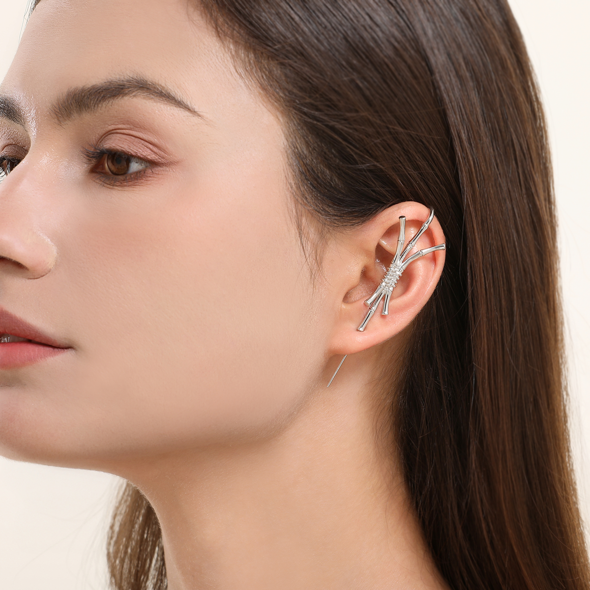 Ward of Protection ear cuff in silver worn on the ear, profile view