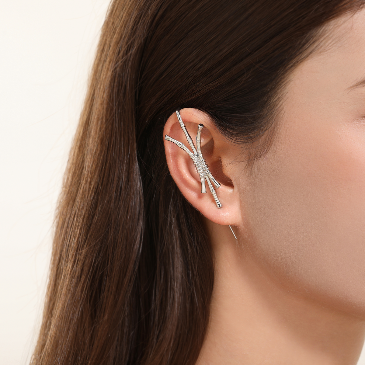 Ward of Protection ear cuff in silver worn on the ear, profile view