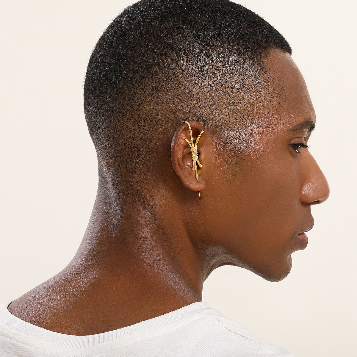 Ward of Protection ear cuff in gold worn on the ear, profile view